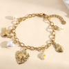 Bracelet doré chaîne charms cœurs divers ex-voto en perle blanche