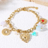 Bracelet chaîne dorée breloques cœur ex-voto perlée