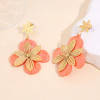 Boucles d'oreilles pendantes double fleur résine orange