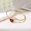 Bracelet manchette dorée avec cristaux de verres blanc et fuchsia