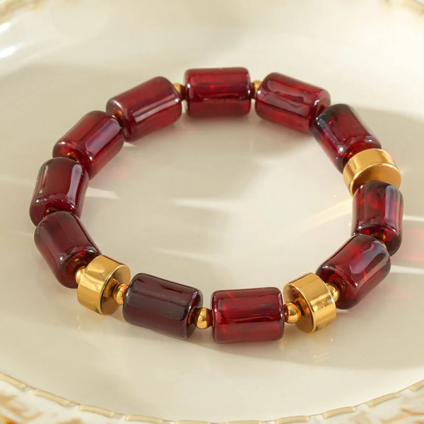 Bracelet élastique résine cylindrique rouge ambré anneaux séparateurs dorés - 1